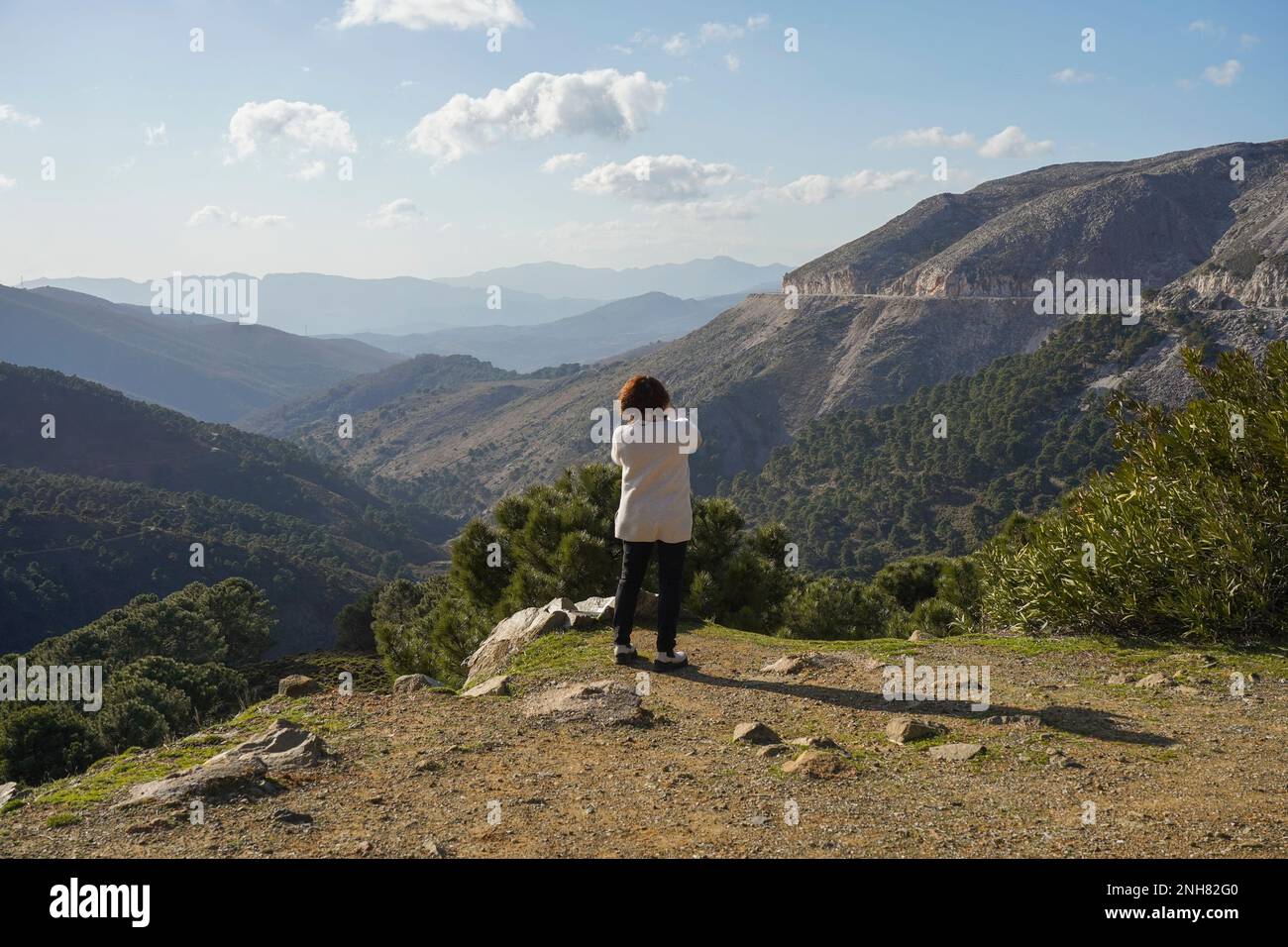 Woman making photo with mobile, in mountain area Serrania de ronda, Spain. Stock Photo