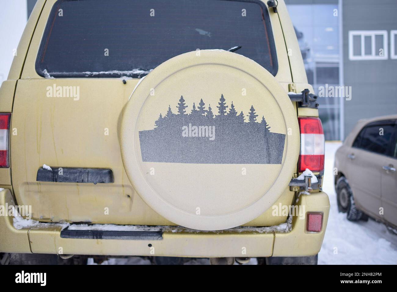 Drawing of forest trees on the spare wheel cover for a Russian 4x4 SUV 'UAZ Patriot' Stock Photo