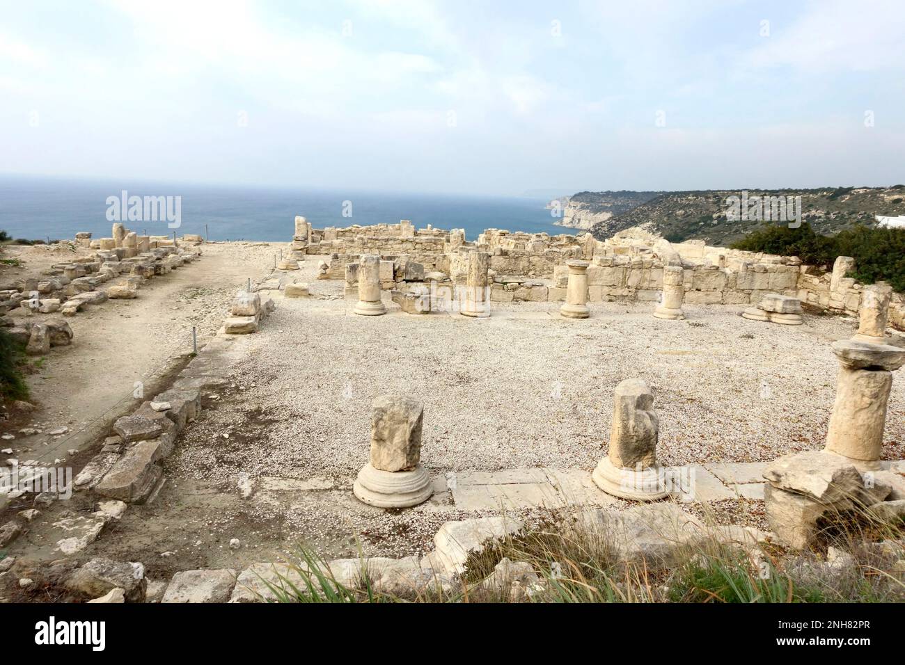 A row of columns left from an ancient Greek temple. The ruins of the building of an ancient civilization in the Paphos area. Nea Paphos and Paphos Arc Stock Photo