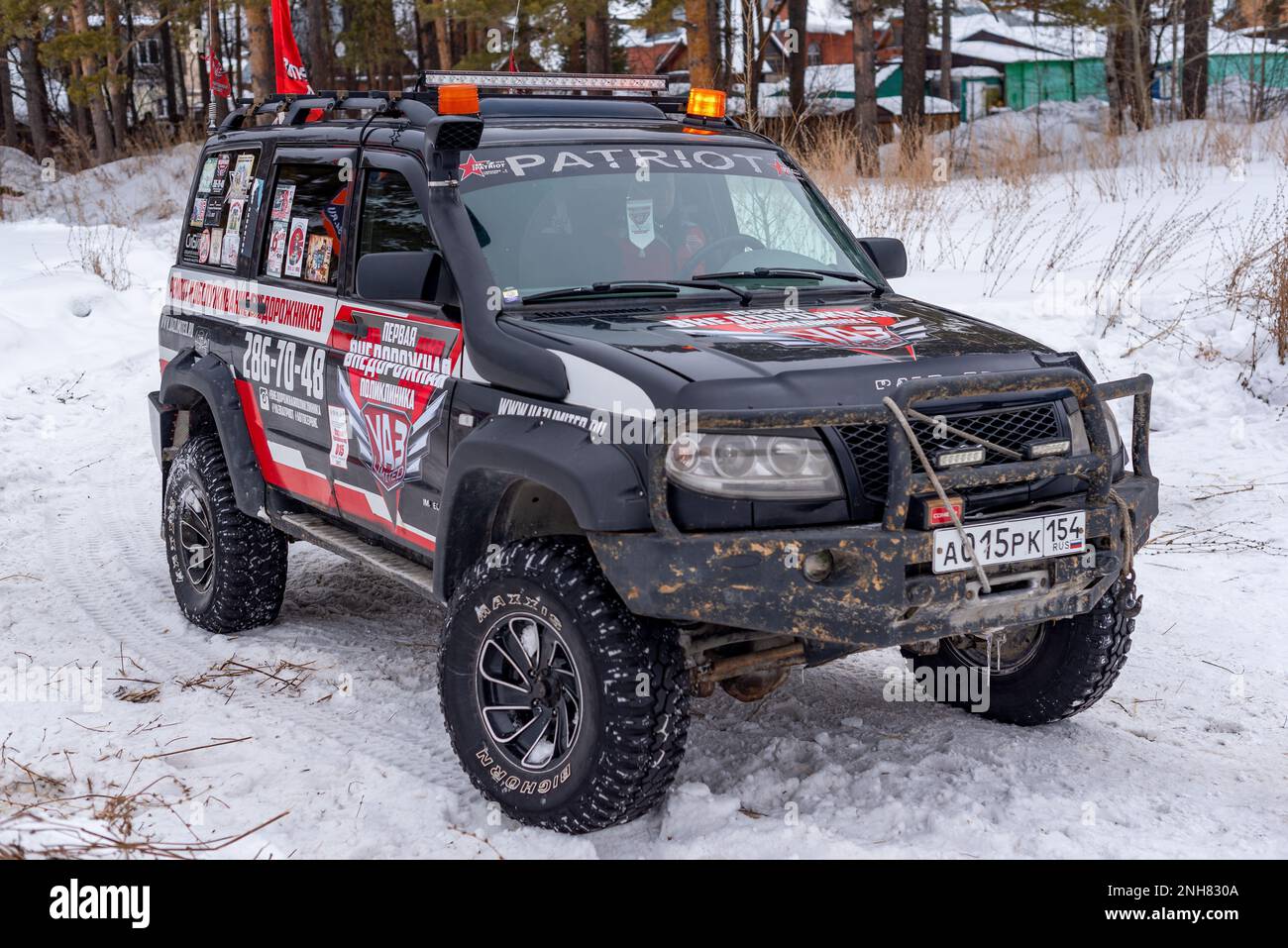 Prepared for off- road evacuation, the Russian 4x4 UAZ Patriot SUV with a protective bumper stands in the snow in winter. Stock Photo