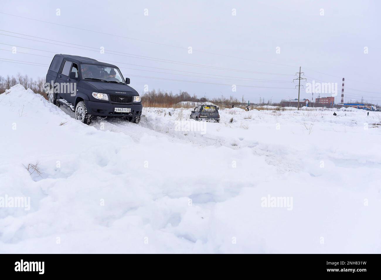 Russian black SUV 'UAZ Patriot' rides on a snow slide in winter. Stock Photo