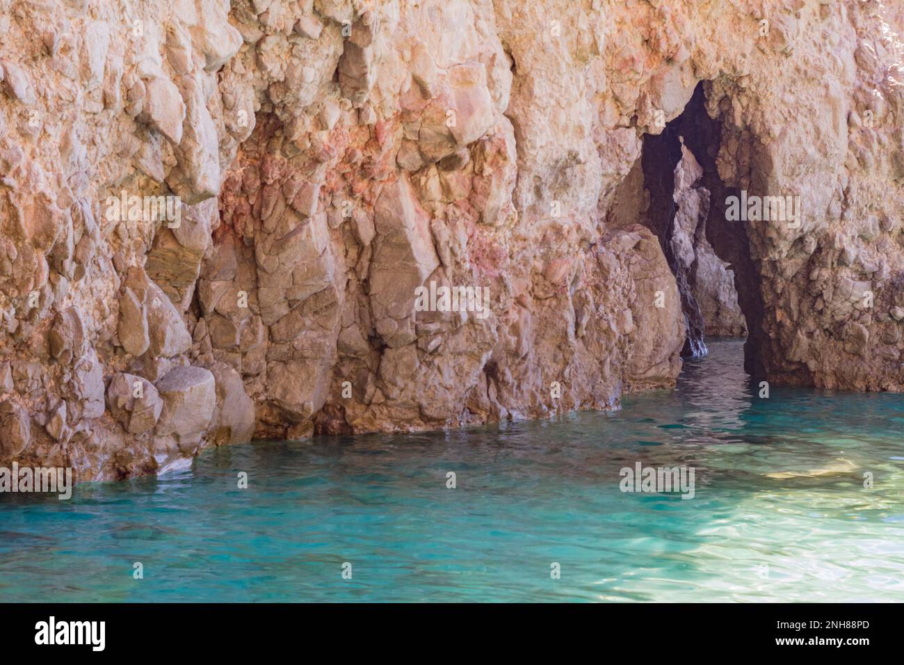 Volcanic rocks and caves in Tsigrado beach, Milos Stock Photo