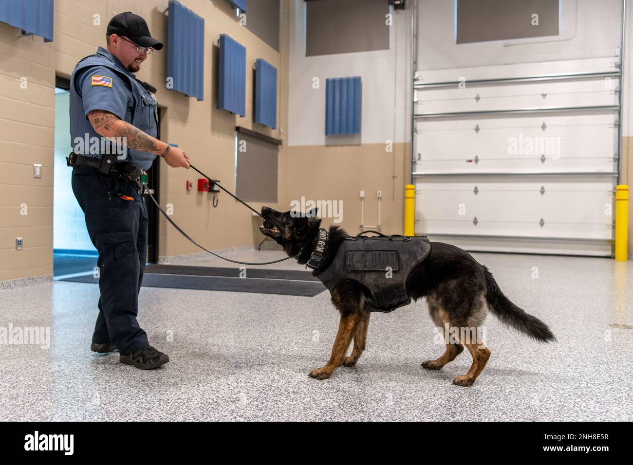 Nicholas Buchan, a K-9 officer assigned to ProMedica Security, rewards Josef, a K-9 assigned to ProMedica Security, with a toy, after finding a hidden training weapon during a practice search at the Ohio National Guard’s 180th Fighter Wing in Swanton, Ohio, July 21, 2022. The K-9 officers visited the 180FW to learn about the unit’s security forces mission, sharing best practices and strengthening community partnerships. Stock Photo