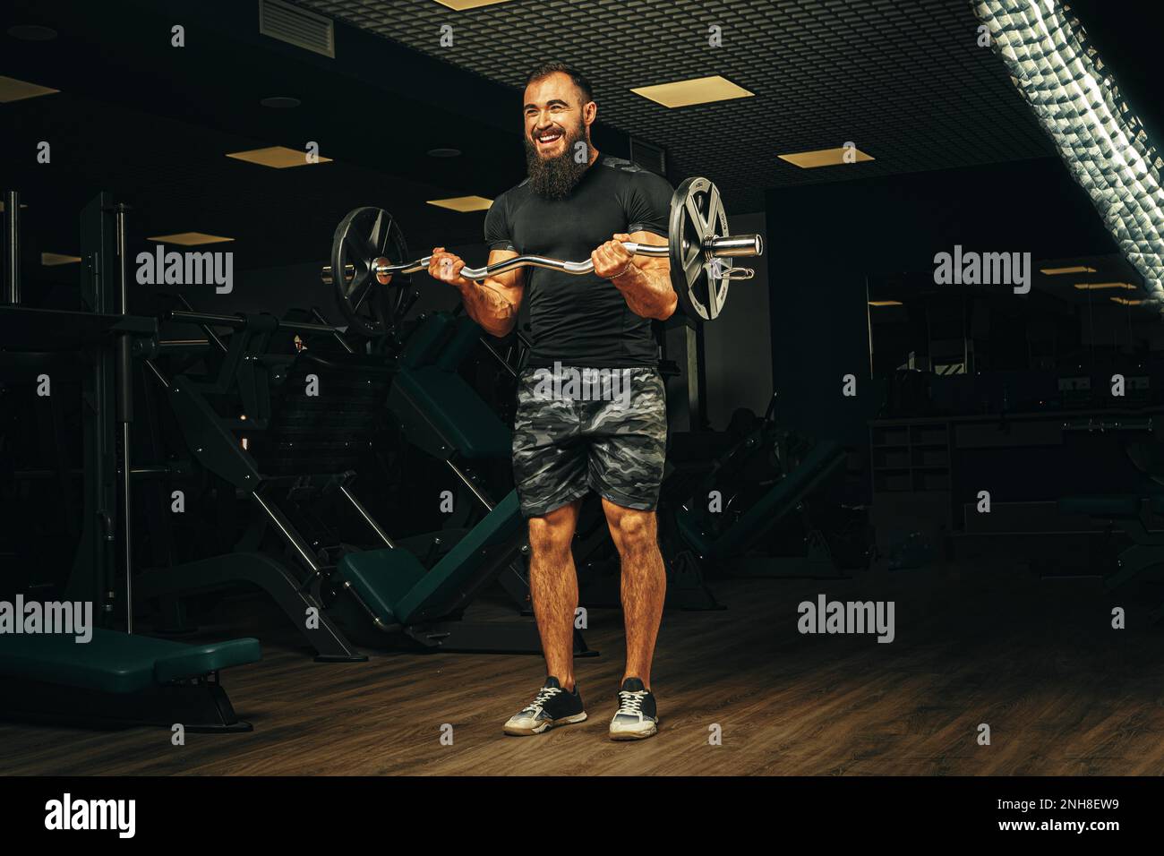 Powerlifter with strong arms lifting barbell in a gym Stock Photo Alamy