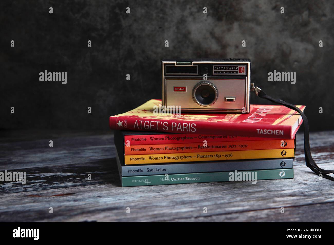 Still life image of Kodak instamatic camera on a stack of photography books Stock Photo