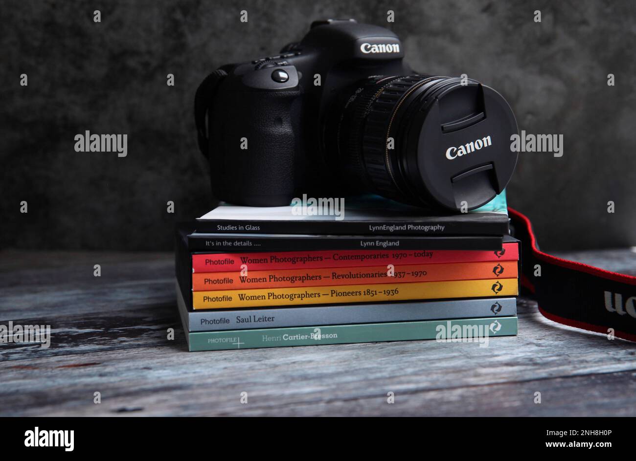 Canon DSLR in still life image on a stack of photography books Stock Photo