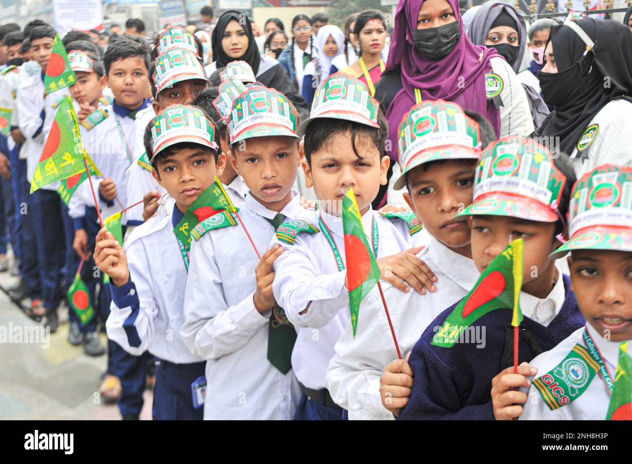 21 February 2023 in Sylhet-Bangladesh: Students holding placard and national flag of Bangladesh in the rally to pay tribute, celebrating the International Mothers Language Day 2023 event at the Shaheed Minar. Moreover, School, college, students, teachers, political and social, cultural organizations and all the professional people of the society offered floral tributes to the language martyrs and language fighters from the dawn at the Sylhet Central Shaheed Minar, Sylhet, Bangladesh,  to observe the International Monthers Language Day and Great Martyr;s Day On 21 February 2023 in Sylhet-Bangla Stock Photo