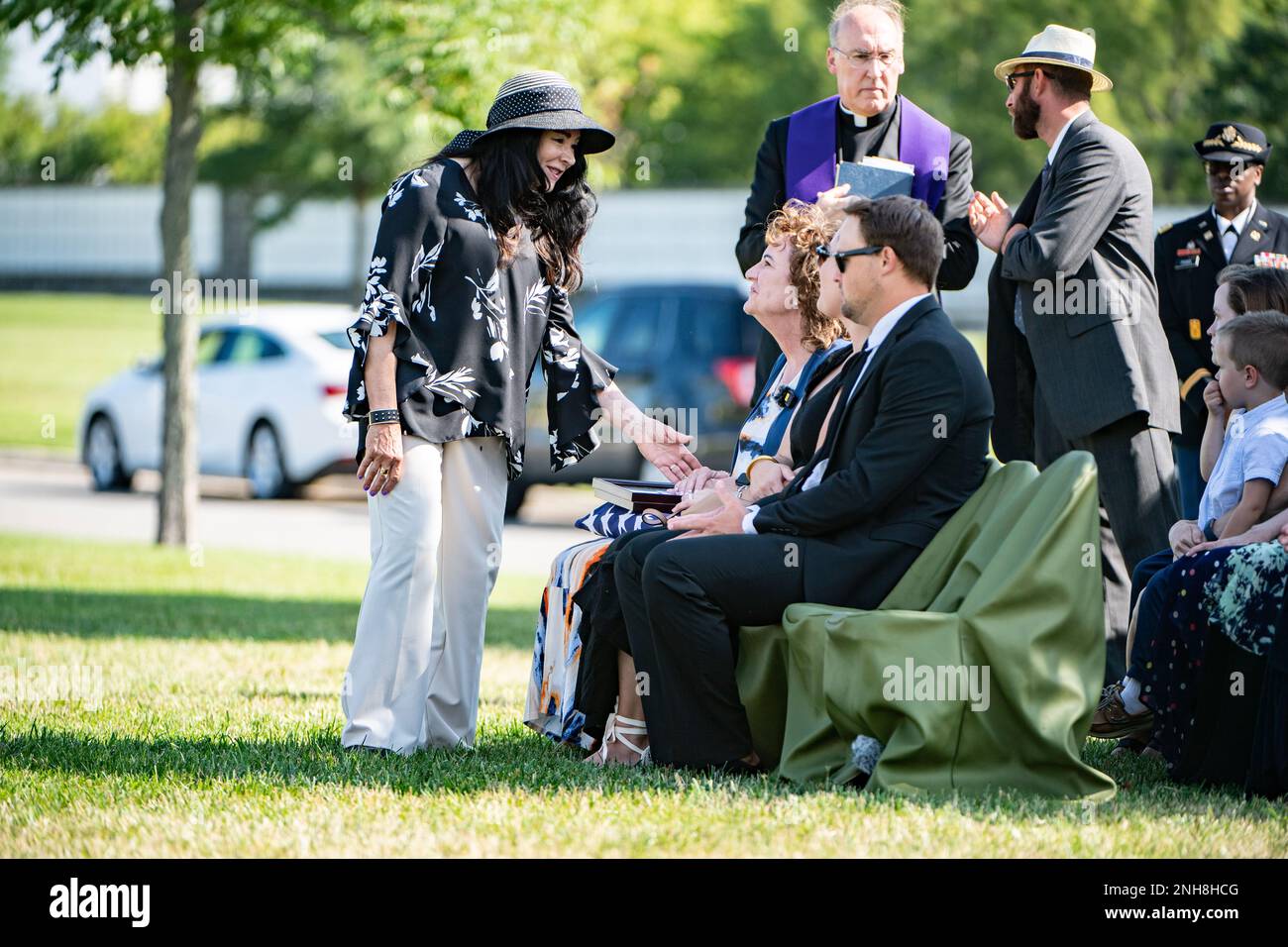 Karen Durham-Aguilera (left), executive director, Army National Military Cemeteries, offers condolences to Mary Hill following the funeral service for Hill's grandfather, U.S. Navy Chief Pharmacist’s Mate James T. Cheshire, in Section 62 of Arlington National Cemetery, Arlington, Va., July 22, 2022. Cheshire died on Dec. 7, 1941 when the battleship he was assigned to, the USS Oklahoma at Ford Island, Pearl Harbor, was attacked by Japanese aircraft.    From the Defense POW/MIA Account Agency (DPAA) press release:    The USS Oklahoma sustained multiple torpedo hits, which caused it to quickly ca Stock Photo