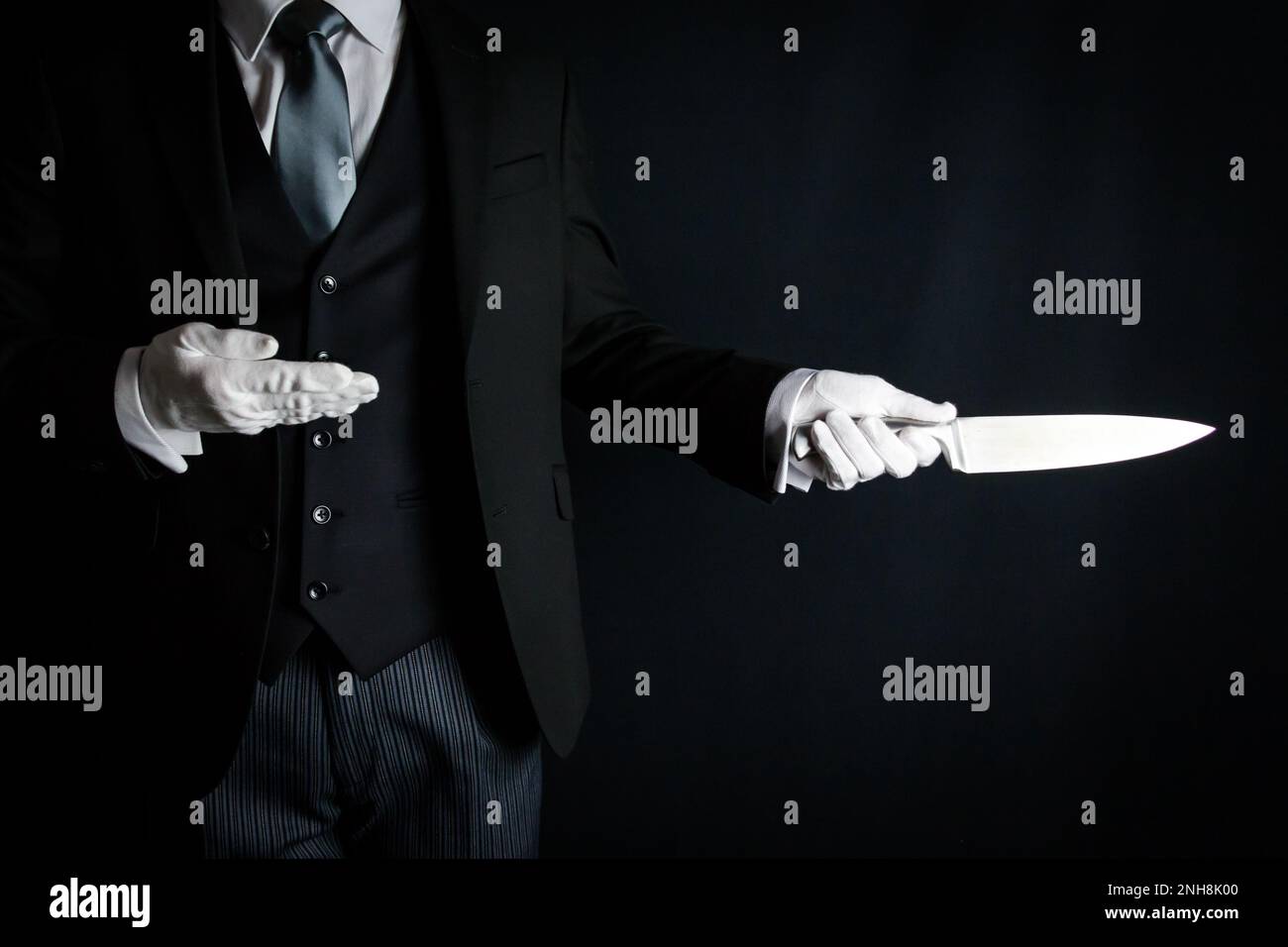 Portrait of Butler in Dark Suit and White Gloves Holding Sharp Knife. Concept of Butler Did It. Stock Photo