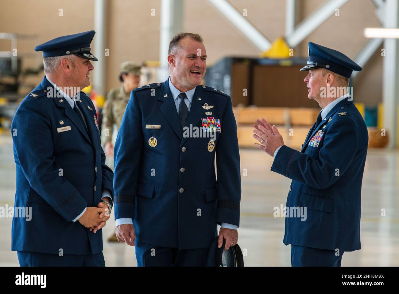 From left to right, U.S. Air Force Col. Corey Simmons, outgoing 60th Air Mobility Wing commander, Maj. Gen. Kenneth Bibb, 18th Air Force commander, and Col. Derek Salmi, incoming 60th Air Mobility Wing commander, visit with each other prior to the wing change of command ceremony at Travis Air Force Base, California, July 27, 2022. A change of command ceremony is a military tradition of formal transfer of command, responsibilities and authority from one commander to another. Stock Photo