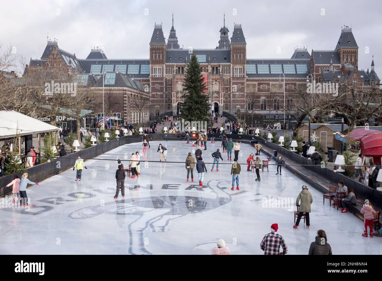 An elevated view of people ice skating on the temporary ice rink set up