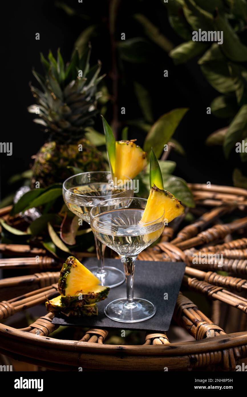 Champagne cocktail with pineapple decoration on a rattan table Stock Photo Alamy