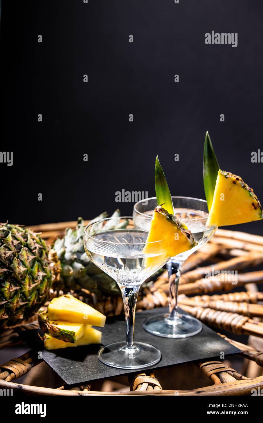 Champagne cocktail with pineapple decoration on a rattan table Stock Photo Alamy