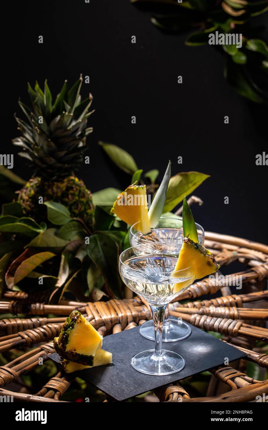 Champagne cocktail with pineapple decoration on a rattan table Stock Photo Alamy