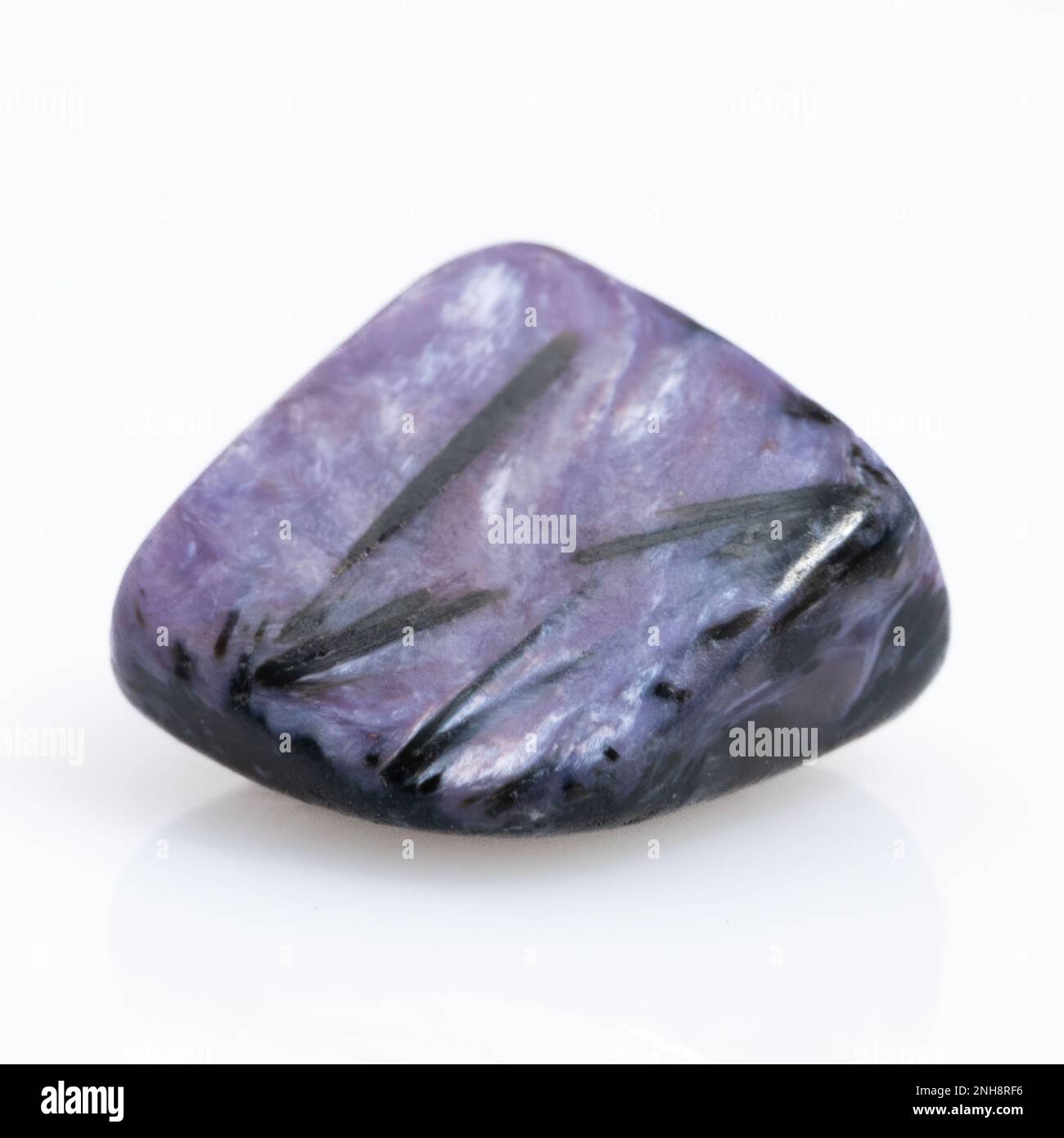 Natural gem purple charoite isolated on white background Stock Photo