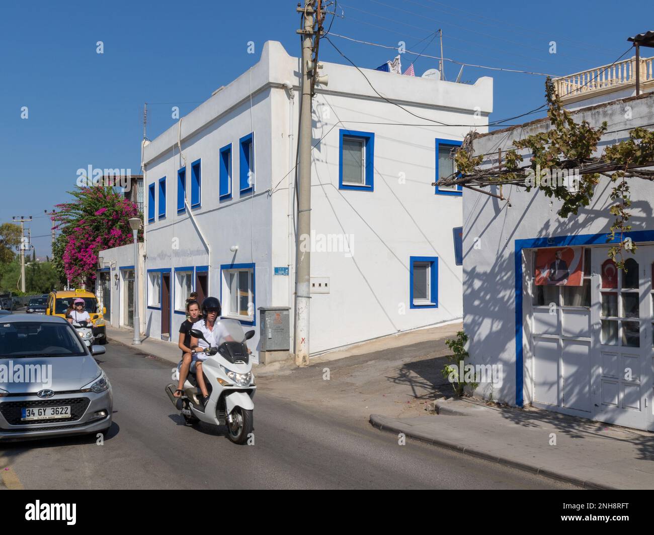 Blue and white building, with passing traffic, Bodrum, Turkey Stock Photo