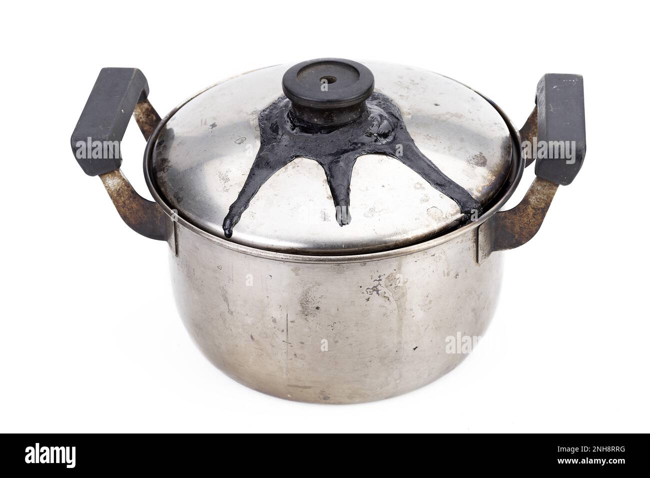 A stainless steel pot with burnt marks closed lid from being left on