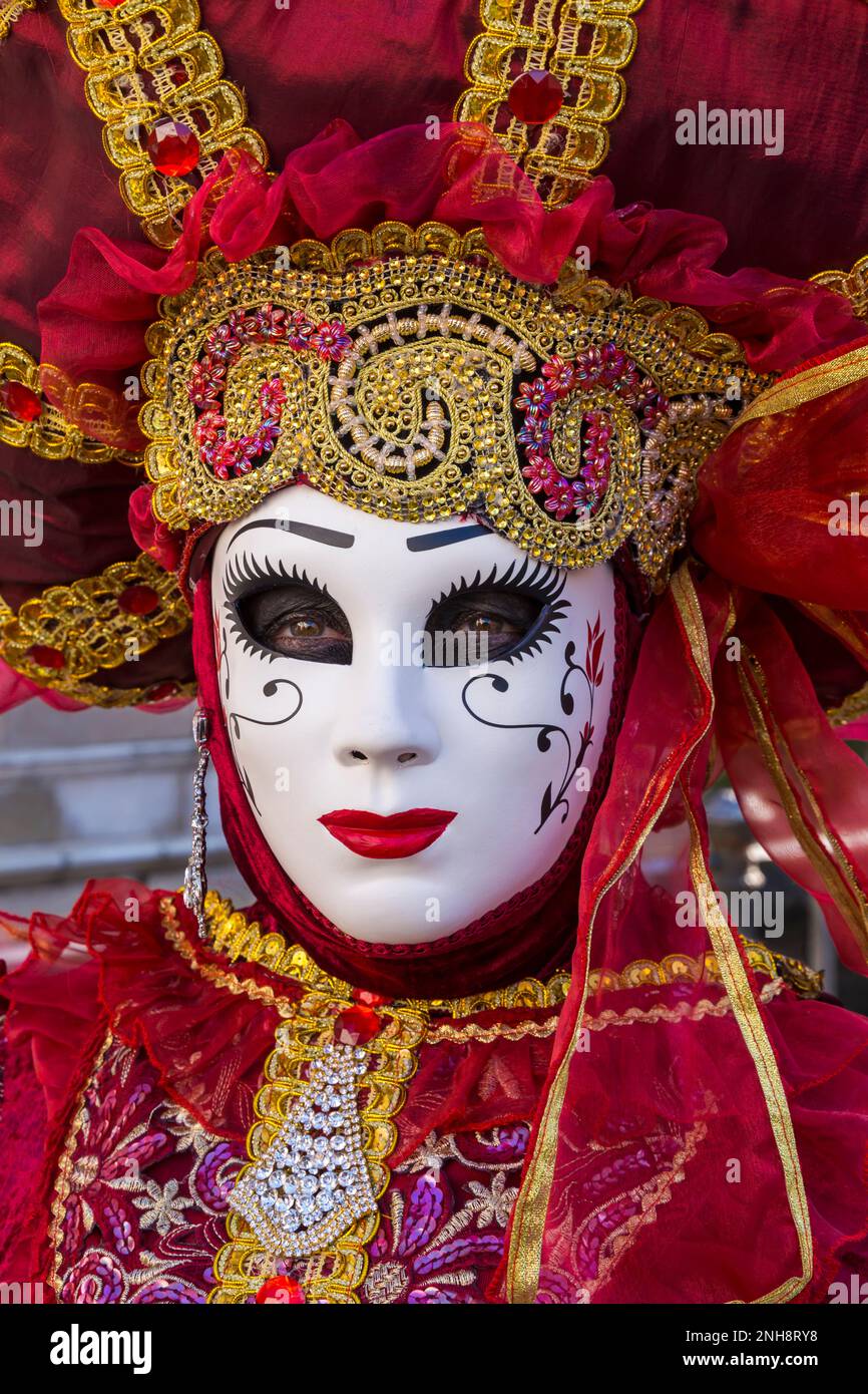 Carnival goer dressed in splendid red and gold coloured costume and mask  during Venice Carnival 2023 at San Polo, Venice, Italy in February Stock  Photo - Alamy