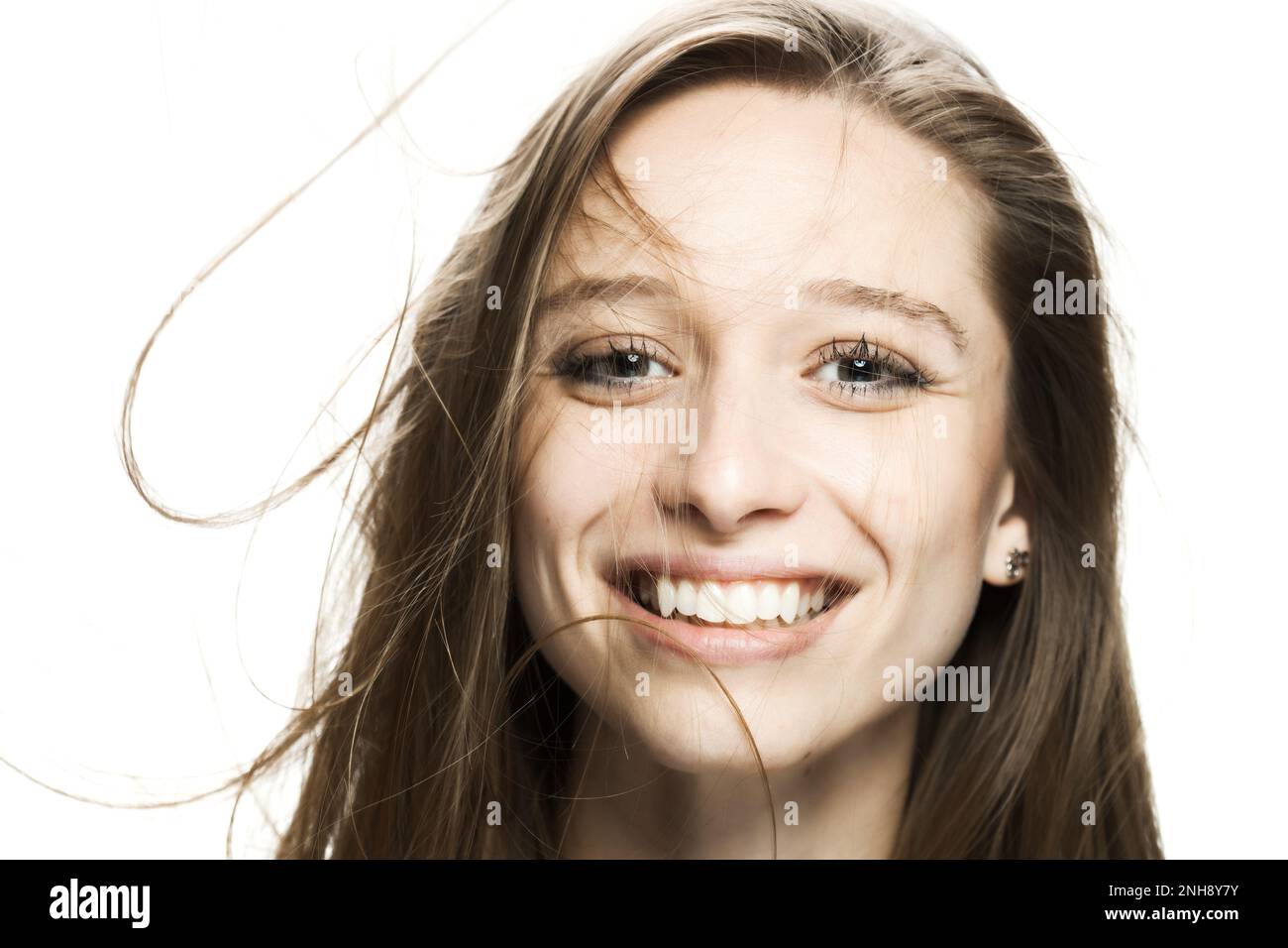 girl with flowing hair in the air studio portrait against