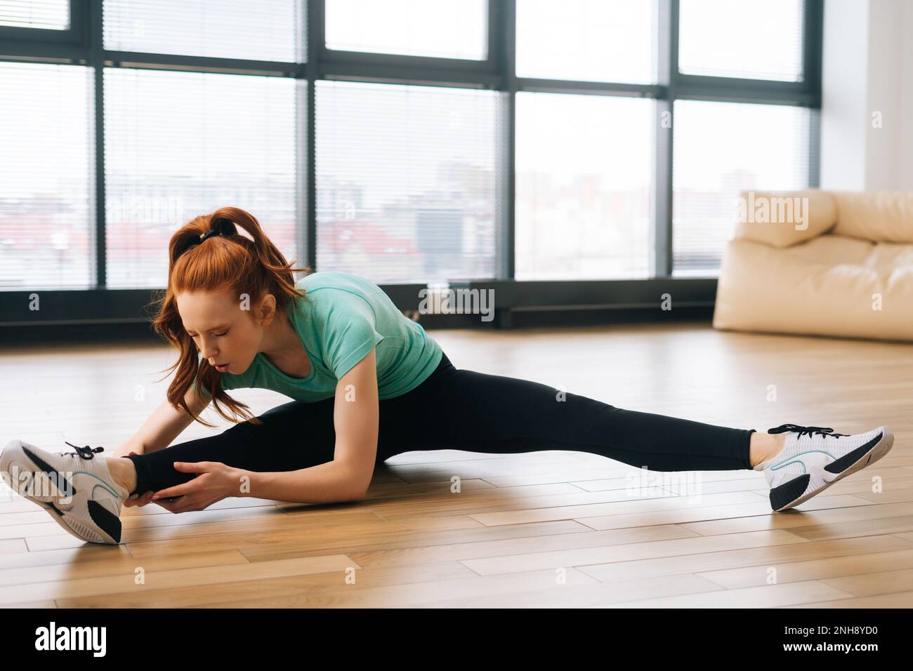 Front view of sporty young woman doing therapeutic exercises for