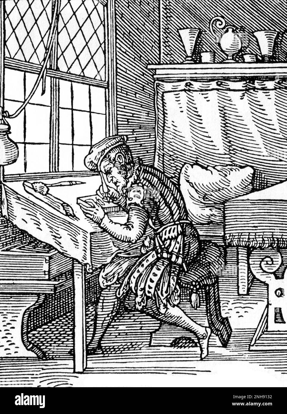 A block-cutter for woodcuts. 1568. Woodcut illustration from Jost Amman's Book of Trades, 1568. Stock Photo