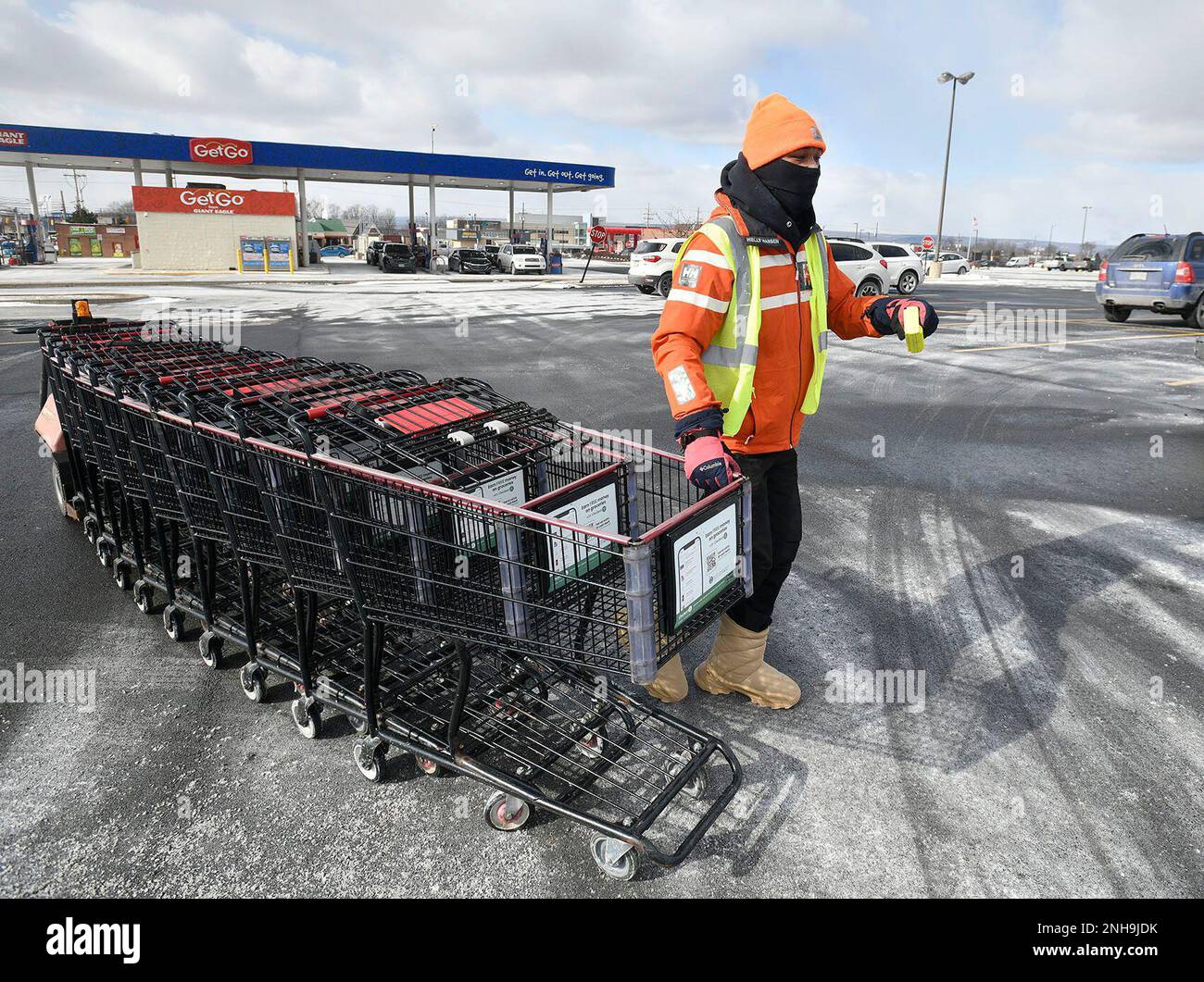 Giant Eagle grocery store employee Cordell Lewis gathers shopping carts