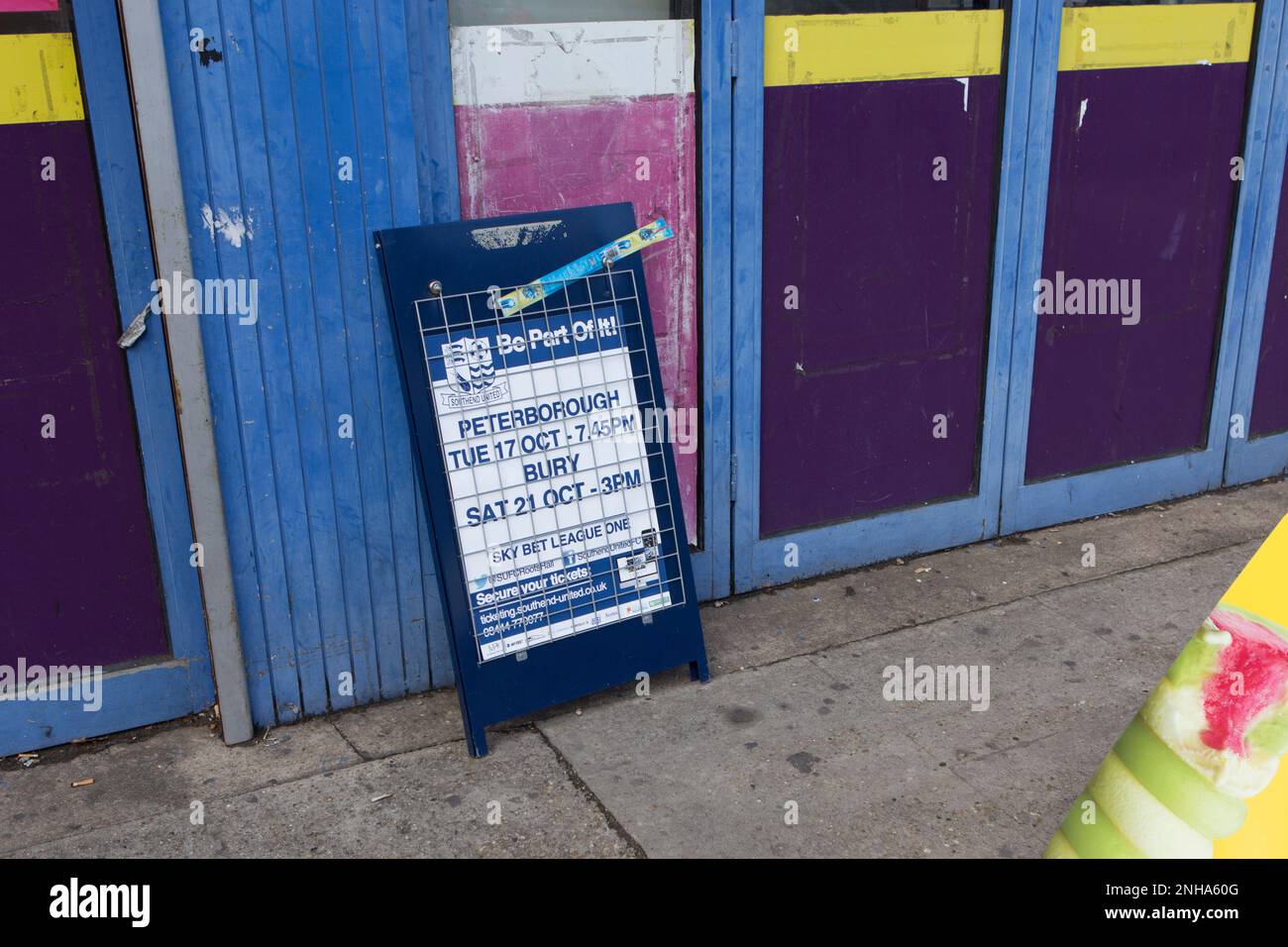 A newspaper billboard outside a grocery store, adverting Southend