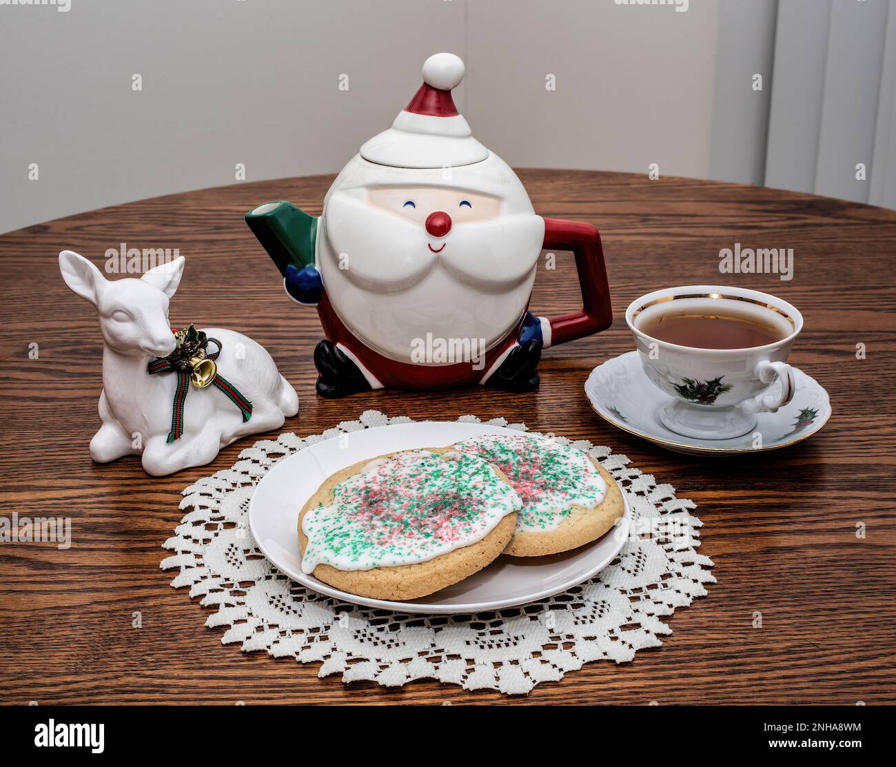 Christmas tea with decorated sugar cookies, a santa claus teapot and a