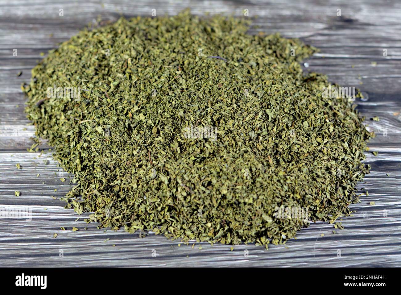 Pile of dried chopped mint leaves, used with meats, fruit desserts, drinks and tea, also for garnishing dishes and platters, Mentha or Mintha is a gen Stock Photo