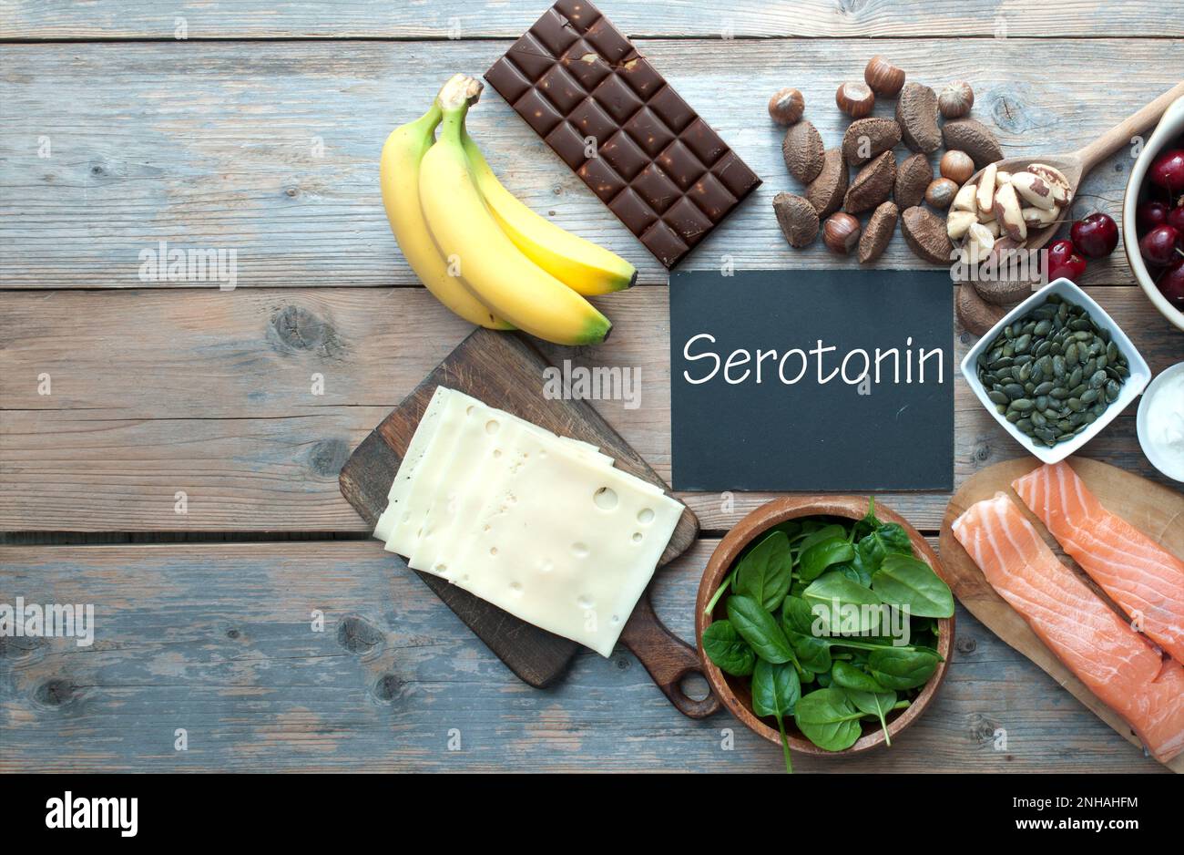 Serotonin, good mood food concept, inlcluding brazil nuts, dark chocolate, cherries and salmon Stock Photo