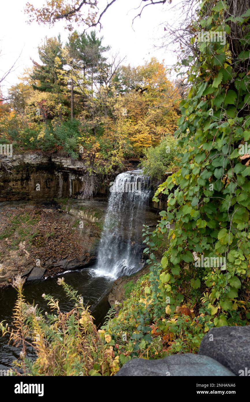 Minnehaha Falls framed with autumn trees changing color. Minneapolis Minnesota MN USA Stock Photo