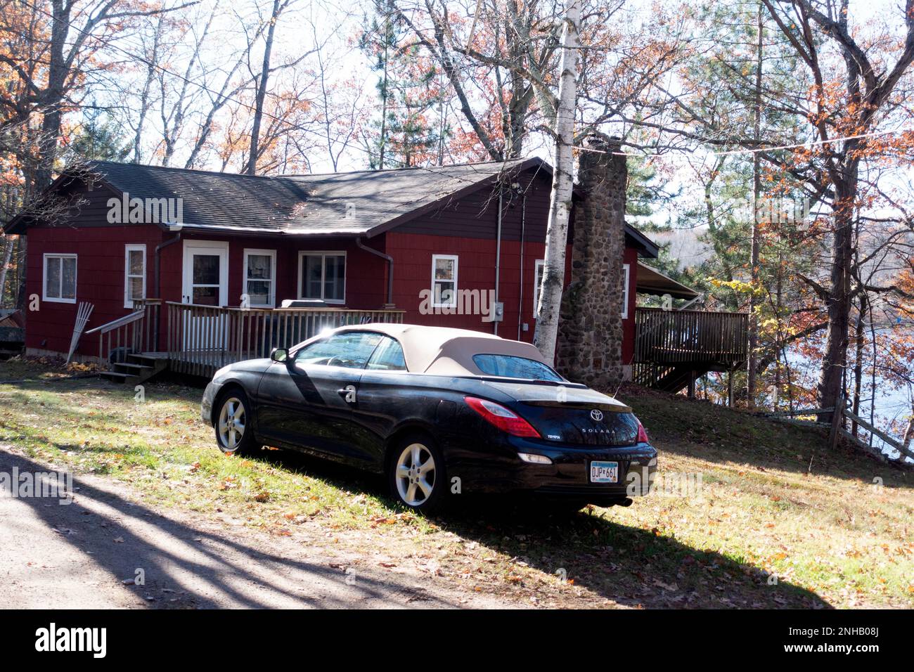 Sleek Toyota Solara convertible sport car parked by cabin on Sand Lake. Cumberland Wisconsin WI USA Stock Photo