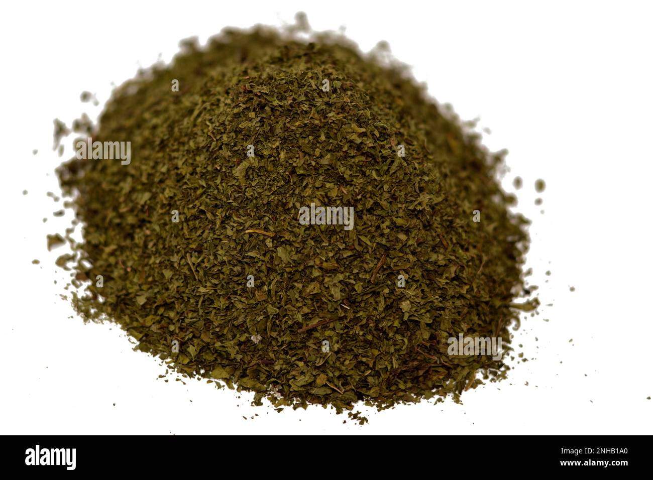 Pile of dried chopped mint leaves, used with meats, fruit desserts, drinks and tea, also for garnishing dishes and platters, Mentha or Mintha is a gen Stock Photo