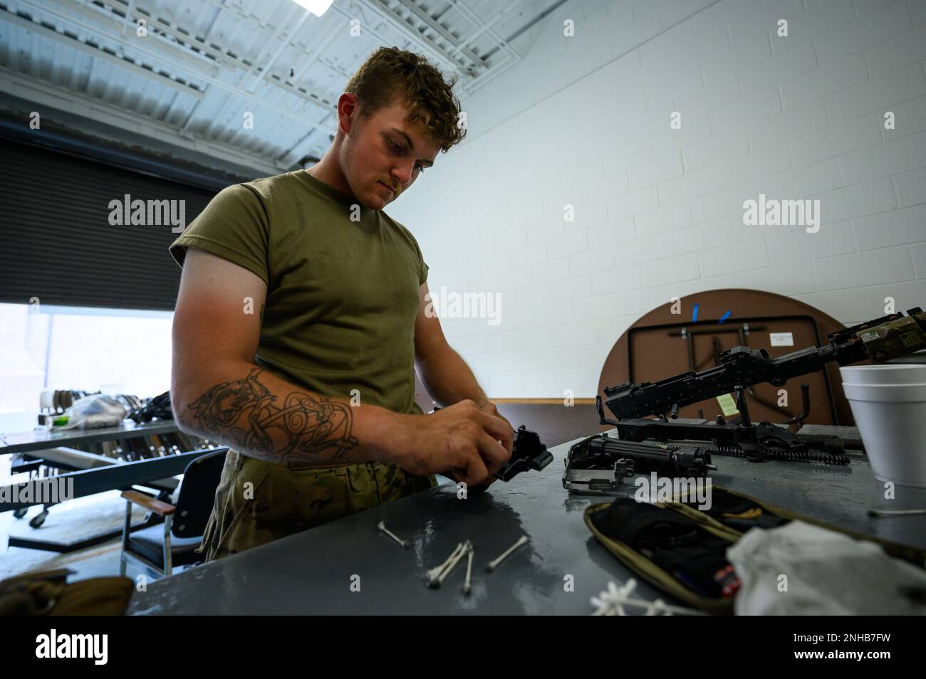 A New Jersey Army National Guard Soldiers from Bravo Company, 1st Battalion, 114th Infantry Regiment, conducts weapons maintenance at the Freehold National Guard Armory in Freehold, New Jersey, July 28, 2022. The Soldiers are cleaning their weapons after returning from the eXportable Combat Training Capability (XCTC) exercise, where more than 2,500 Soldiers participated in training event held in Fort Drum, New York, which enables brigade combat teams to achieve the trained platoon readiness necessary to deploy, fight, and win. Stock Photo