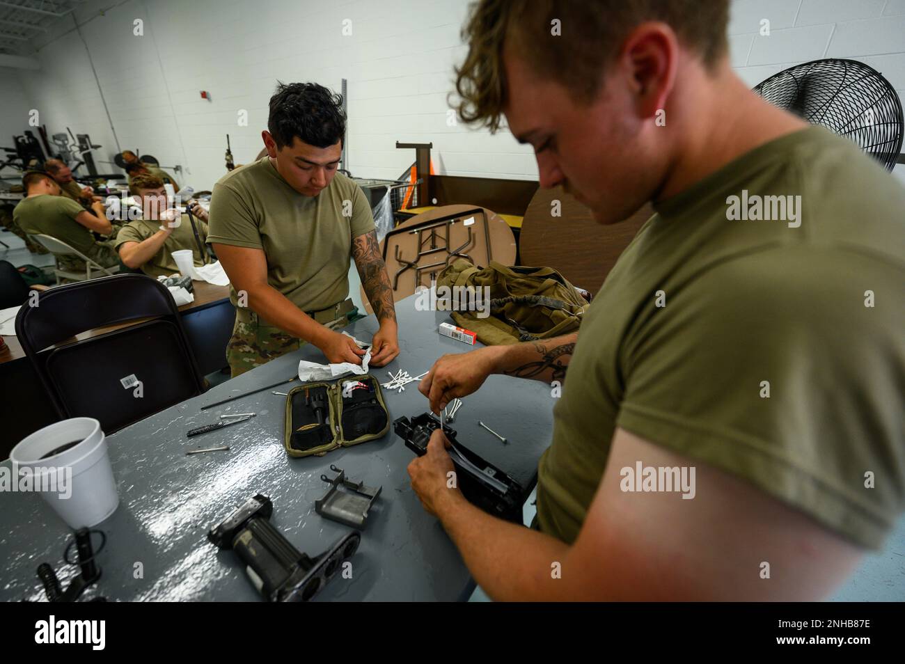 New Jersey Army National Guard Soldiers from Bravo Company, 1st Battalion, 114th Infantry Regiment, conduct weapons maintenance at the Freehold National Guard Armory in Freehold, New Jersey, July 28, 2022. The Soldiers are cleaning their weapons after returning from the eXportable Combat Training Capability (XCTC) exercise, where more than 2,500 Soldiers participated in training event held in Fort Drum, New York, which enables brigade combat teams to achieve the trained platoon readiness necessary to deploy, fight, and win. Stock Photo