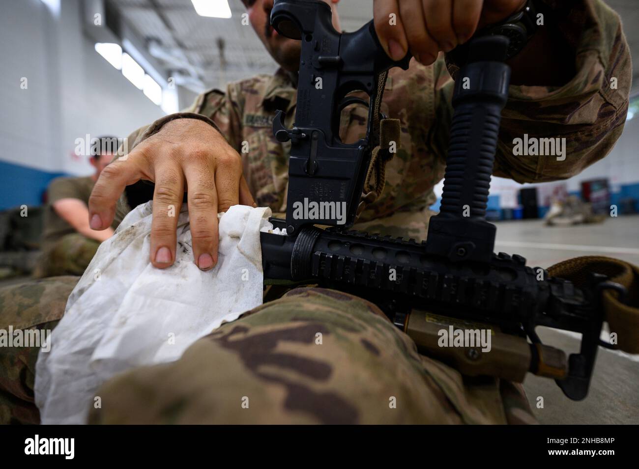 U.S. Army Sgt. Kirby Vargas, from Bravo Company, 1st Battalion, 114th Infantry Regiment, conducts weapons maintenance at the Freehold National Guard Armory in Freehold, New Jersey, July 28, 2022. The Soldiers are cleaning their weapons after returning from the eXportable Combat Training Capability (XCTC) exercise, where more than 2,500 Soldiers participated in training event held in Fort Drum, New York, which enables brigade combat teams to achieve the trained platoon readiness necessary to deploy, fight, and win. Stock Photo
