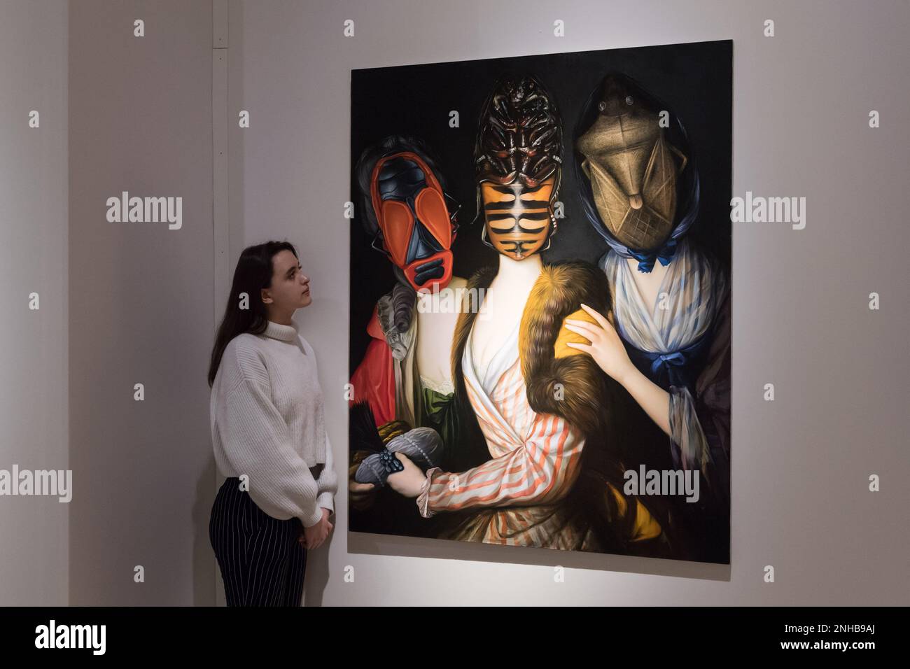 London, UK. 21st Feb, 2023. LONDON, UNITED KINGDOM - FEBRUARY 21, 2023: A staff member looks at a painting titled 'Sisters' by Ewa Juszkiewicz (2014) estimate: £300,000-500,000 during a photo call for the upcoming 20th/21st Century Evening Sale and The Art of the Surreal Evening Sale in London, United Kingdom on February 21, 2023. (Photo by WIktor Szymanowicz/NurPhoto) Credit: NurPhoto SRL/Alamy Live News Stock Photo