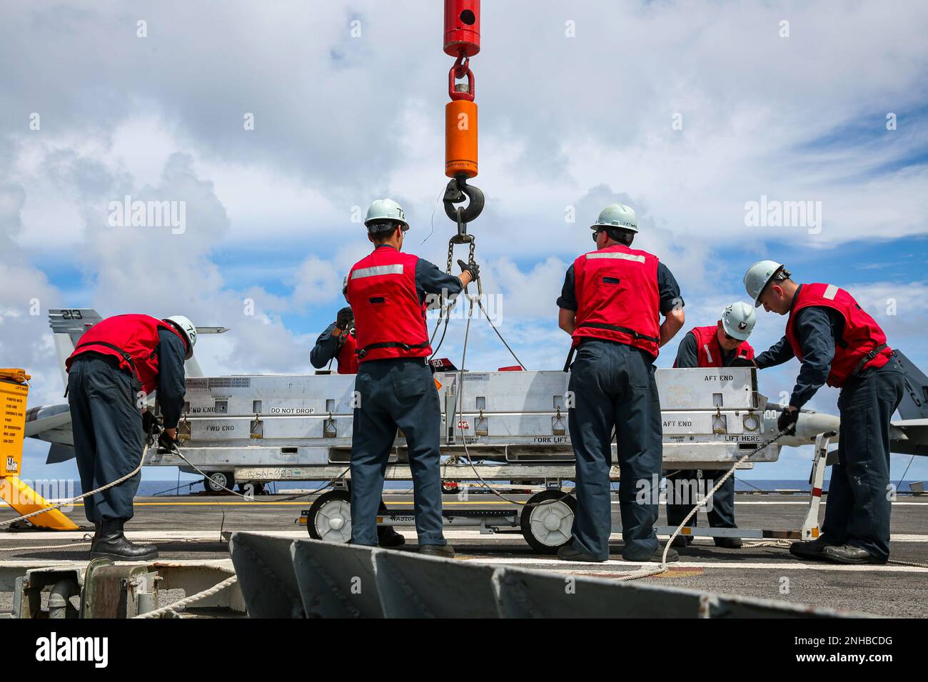 220728-N-VI910-2202 PACIFIC OCEAN (July 28, 2022) Sailors use a crane ...