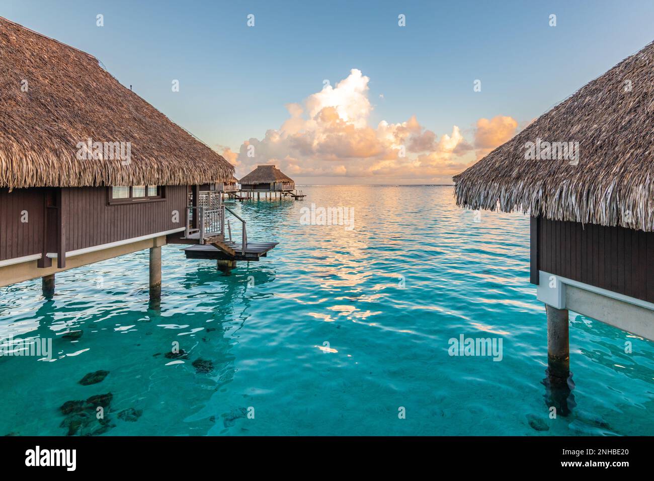 Luxury overwater bungalows in tropical lagoon of Moorea Island. Stock Photo