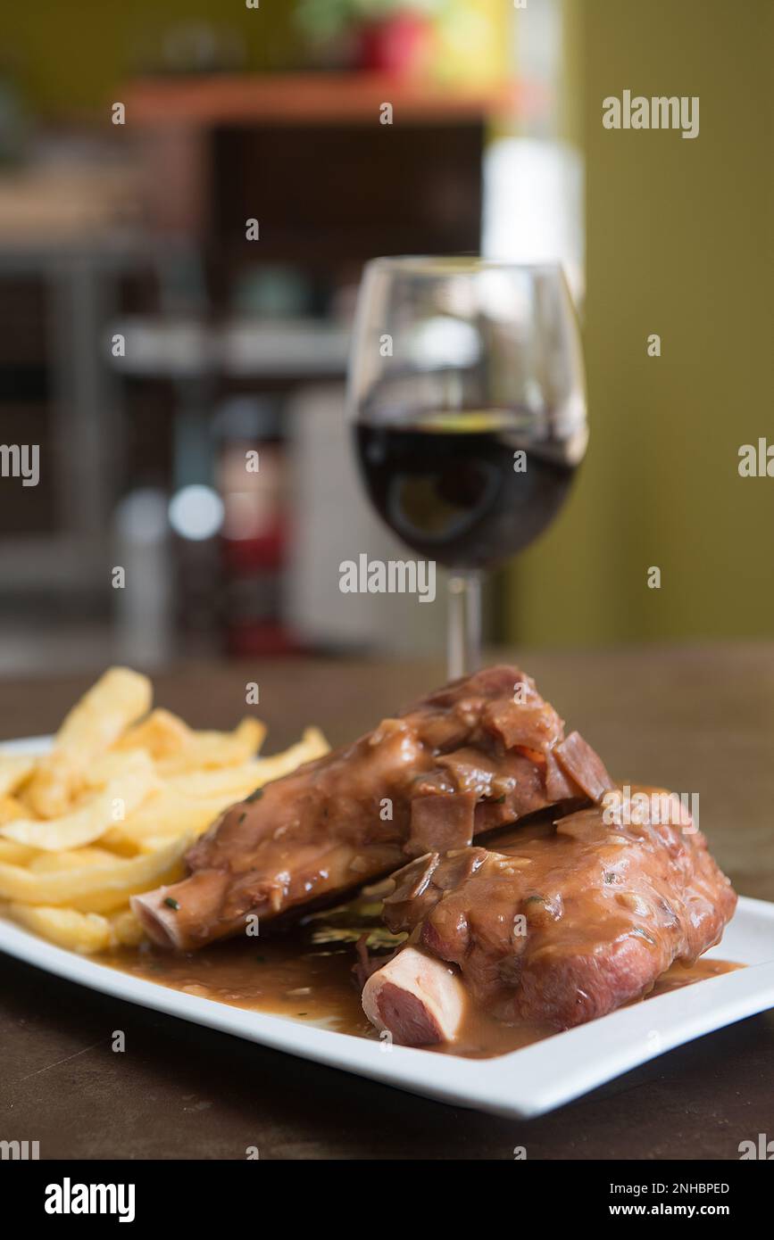 delicious beef knuckle with a glass of wine Stock Photo