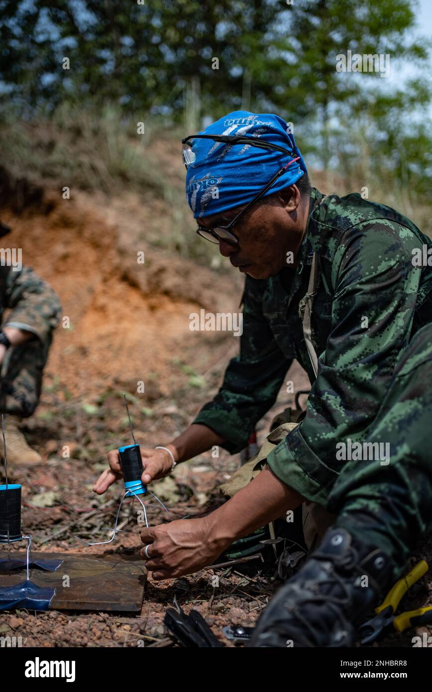 Royal Thai Armed Forces SM1 Sarawut Parung, a Thailand Mine Action Center Explosive Ordnance Disposal student with Humanitarian Mine Action Unit 1, places an improvised shaped charge during an HMA EOD Level 3 course at Ta Mor Roi Training area in Surin Province, Thailand, Jul. 28, 2022. Royal Thai and American Armed Forces work together to train TMAC students in EOD level 3 in order to develop an EOD capacity to assist TMAC’s mission of becoming landmine free. This partnership is aligned with the U.S. Department of Defense’s Humanitarian Mine Action Program, which assists partnered nations aff Stock Photo