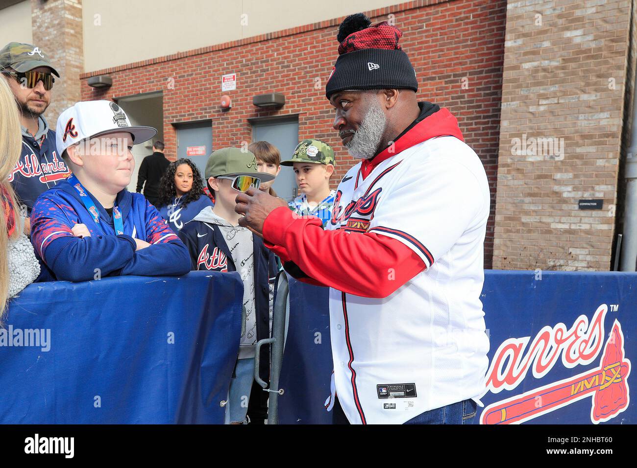 ATLANTA, GA - JANUARY 21: Braves coach Eric Young, Sr. talks to a young fan  during the 2023 Braves Fest on January 21, 2023 at The Battery and Truist  Park in Atlanta