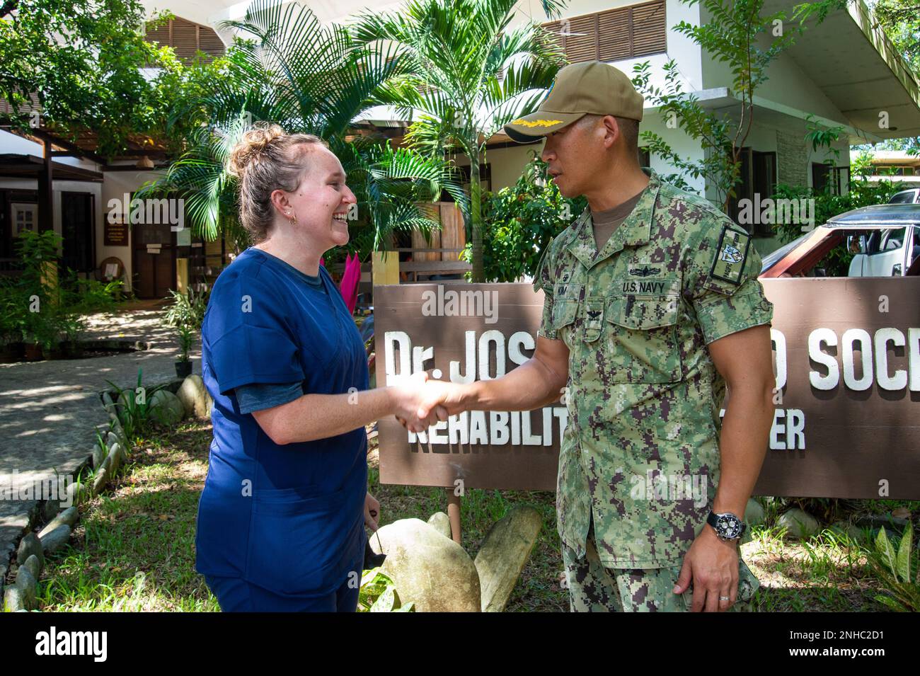 PUERTO PRINCESA, Philippines (July 28, 2022) — Capt. Hank Kim, Pacific Partnership 2022 (PP22) mission commander, right, presents a coin to Sarah Toone, an American Red Cross volunteer serving with PP22, at the Dr. Jose Antonio Socrates Rehabilitation Center during PP22. Now in its 17th year, Pacific Partnership is the largest annual multinational humanitarian assistance and disaster relief preparedness mission conducted in the Indo-Pacific. Stock Photo