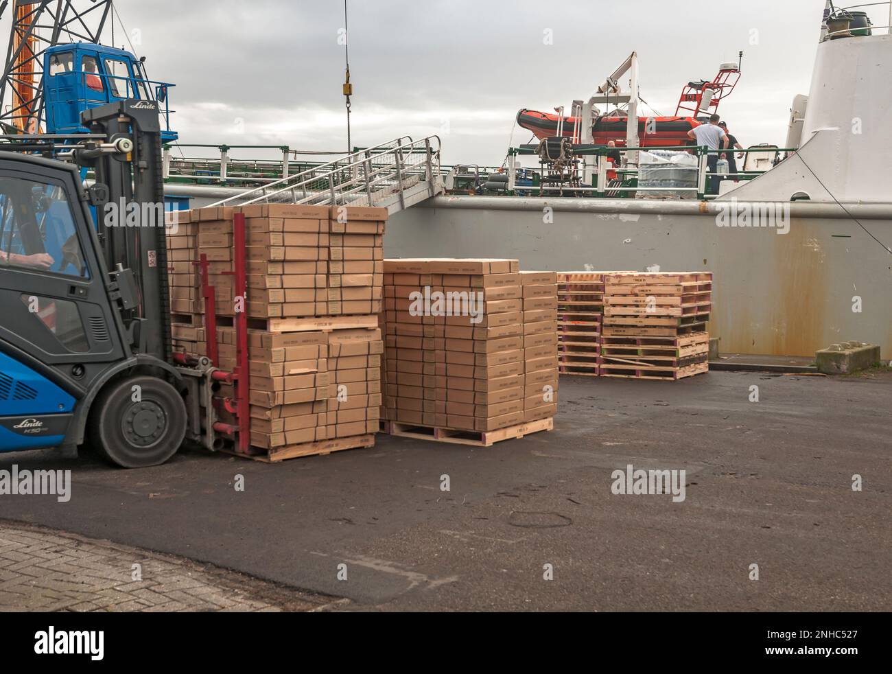 forklift loaded with frozen packs of fish on the quay Stock Photo