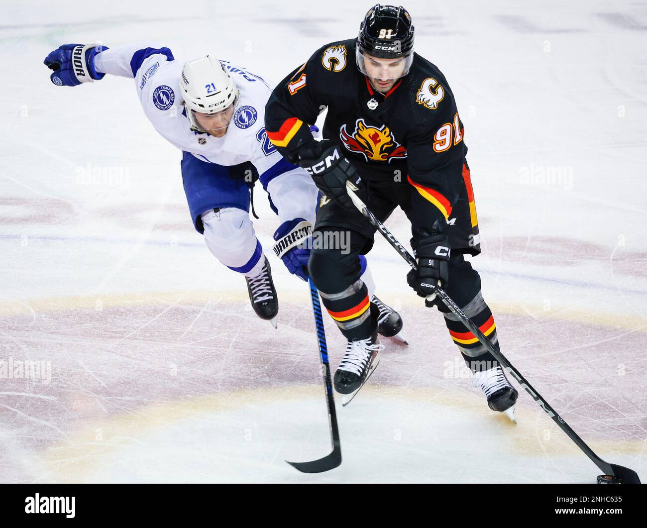 Tampa Bay Lightning forward Brayden Point, left, checks Calgary Flames forward Nazem Kadri