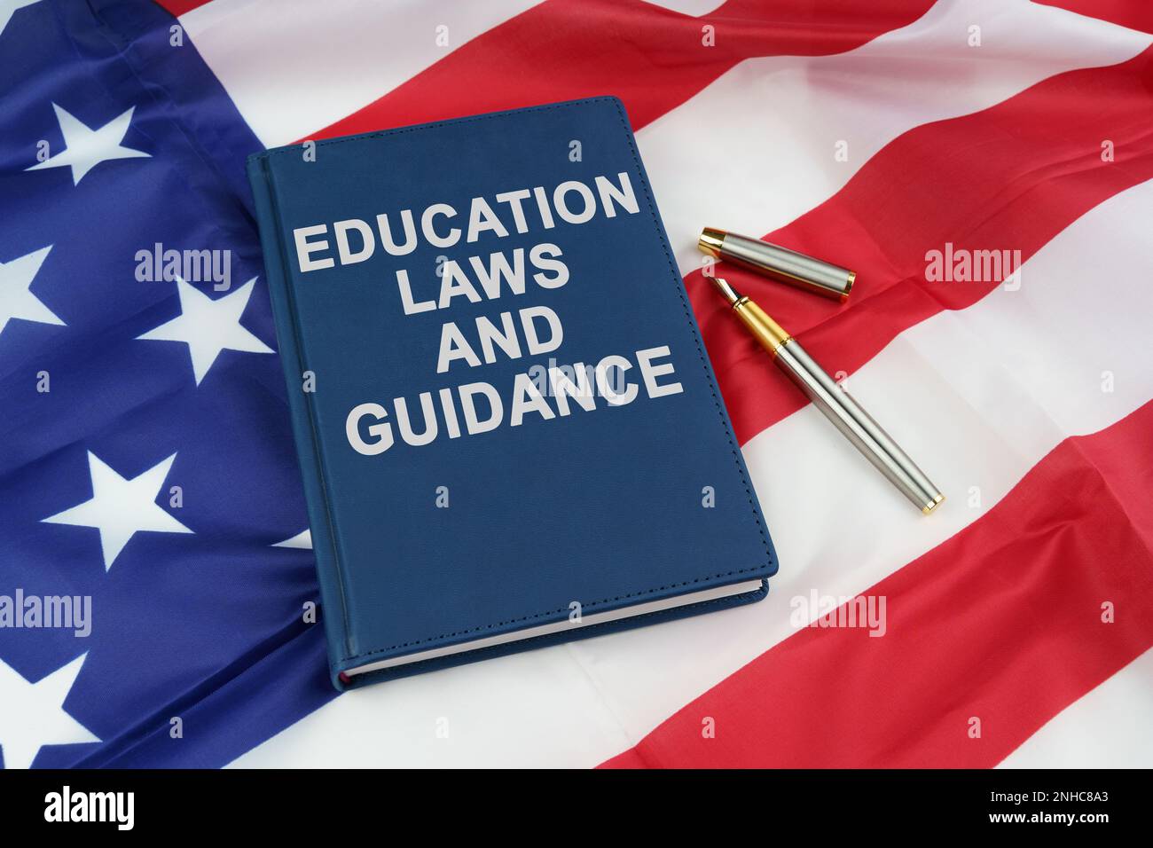 Law concept. On the US flag lies a pen and a book with the inscription