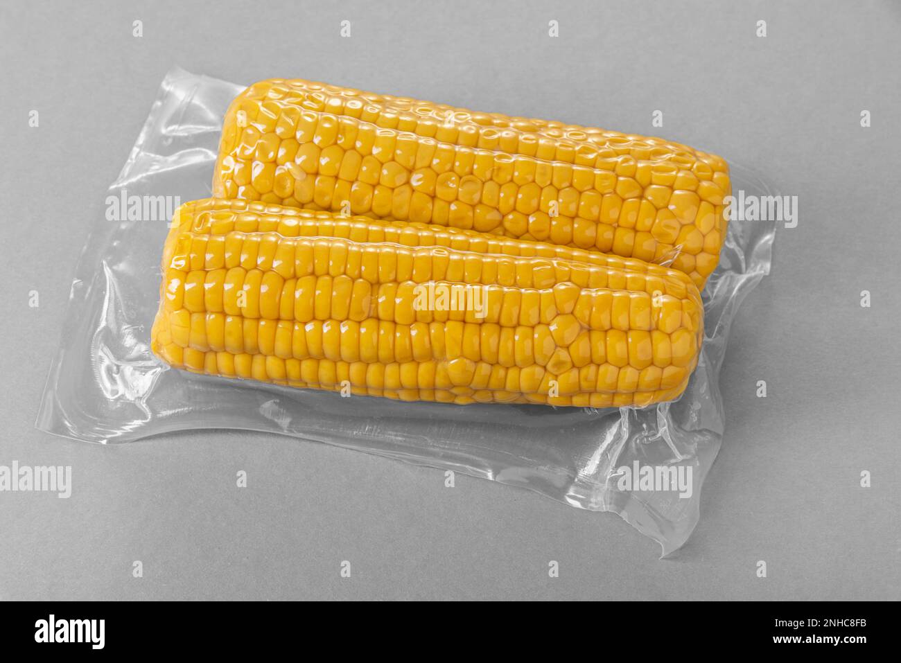 Corn cob in vacuum pack for sous vide cooking on gray background Stock