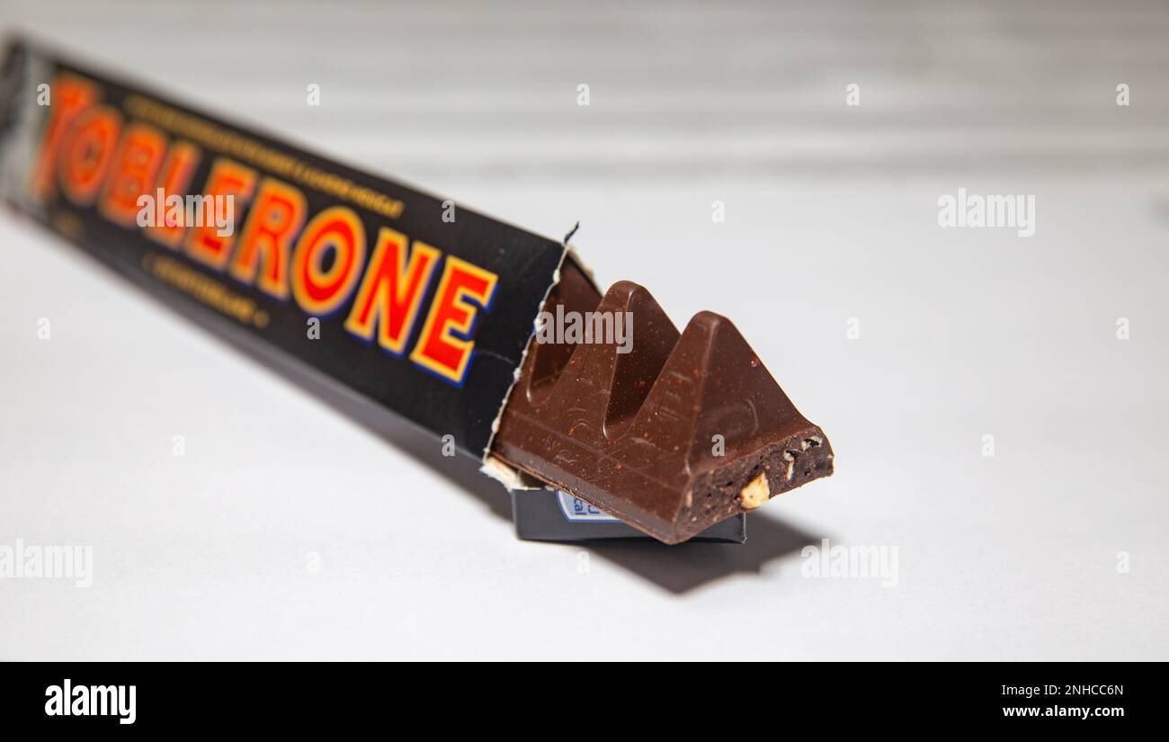 Traditional dark toblerone chocolate isolated in selective focus Stock