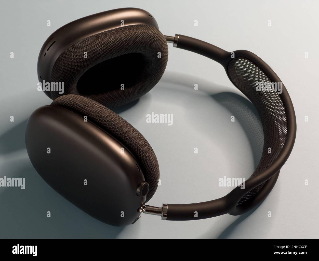 a beautiful pair of space gray Apple Airpods Max headphones, on a clear