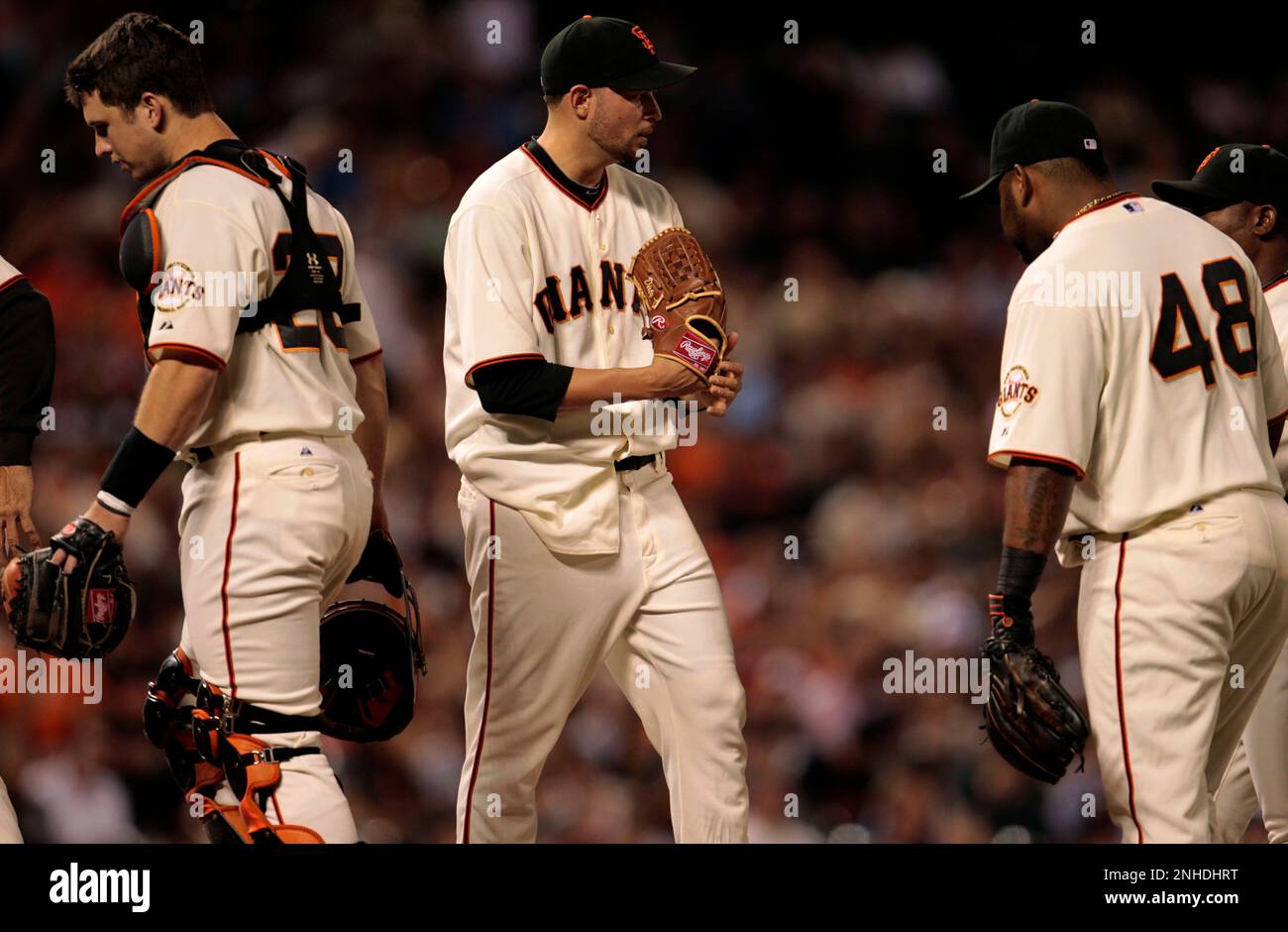 Giants starting pitcher Jonathan Sanchez is joined by catcher Buster Posey  and Pablo Sandoval in the second inning with the bases loaded at AT&T Park  on Tuesday. (Michael Macor/San Francisco Chronicle via